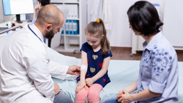 Caring medical doctor consulting girl in office with stethoscope checking breath. Specialist in medicine providing health care service consultation diagnostic examination treatment in hospital cabinet