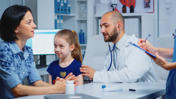 Caring medical doctor consulting girl in office with stethoscope checking breath. Specialist in medicine providing health care service consultation diagnostic examination treatment in hospital cabinet